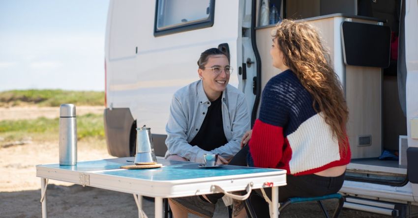 RV Trip - Man and Woman Sitting at Table